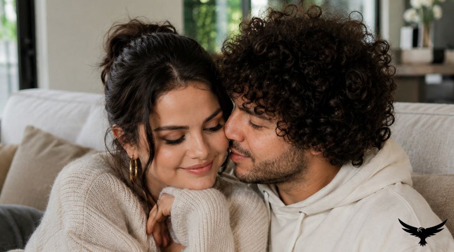 Selena Gomez and Benny Blanco share a quiet affectionate moment together at home, relaxing on a comfortable cozy sofa inside. 